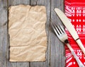 Paper, fork and knife on kitchen towel Royalty Free Stock Photo
