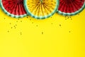 Paper fruit origami watermelon fan decoration. Creative banner with copy space on bright yellow background. Tropics