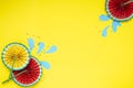 Paper fruit origami watermelon fan decoration. Creative banner with copy space on bright yellow background. Tropics