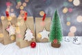 Paper gift bags and small christmas fir tree against silver back Royalty Free Stock Photo