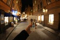 A paper glass of coffee in a man`s hand in a night street Stockholm