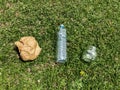 Paper, glass and plastic garbage on green grass top view. Recycle concept. trash can in the grass in park. Ecological problem. Gar