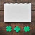 Paper green clover shamrock leaf border on dark wooden background Royalty Free Stock Photo