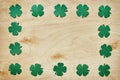 Paper green clover shamrock leaf frame on light plywood background. Royalty Free Stock Photo