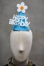 A paper hat with happy birthday banner