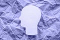 Paper head on purple background, mental health and psychology