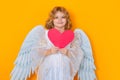 Paper heart, Child with angel wings hold red heart. Heart symbol love and valentines day. Valentine's day. Blonde Royalty Free Stock Photo