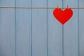 Paper Heart of love with wooden clips on rope on blue wooden background Royalty Free Stock Photo