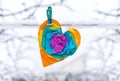 Paper heart.Multicolored paper heart on a clothespin. Heart from crumpled paper on a snowy background Royalty Free Stock Photo