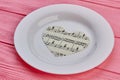 Paper heart with music notes on plate. Royalty Free Stock Photo