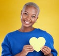 Paper heart, portrait and happy black woman in studio, background and color backdrop. Smile, female model and yellow