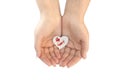 Paper heart protected in cupped hands Royalty Free Stock Photo
