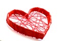 paper heart tied with red threads. Heart on a white background.