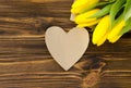 Paper heart, yellow tulips on wooden table Royalty Free Stock Photo