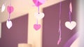 Paper hearts dangle on ribbons, Valentine`s day, indoors