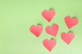 Paper hearts on a green background. one inside symbolizes breakup with someone, breakdown, depression