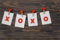 Paper hearts with xoxo inscription in red clothespins with heart on rope on wooden background Royalty Free Stock Photo