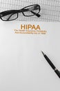 Paper with HIPAA The Health Insurance Portability and Accountability Act of 1996 on a table Royalty Free Stock Photo