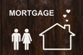 Paper house and family with mortgage text. Conceptual image Royalty Free Stock Photo