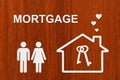 Paper house and family with mortgage text. Conceptual image Royalty Free Stock Photo