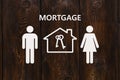 Paper house and family with mortgage text. Conceptual image Royalty Free Stock Photo