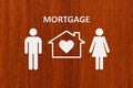 Paper house and family with mortgage text. Conceptual image Royalty Free Stock Photo