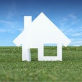 Paper house in the green grass field Royalty Free Stock Photo