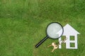 Paper house and key with Magnifying Glass, Green Living hunting Royalty Free Stock Photo