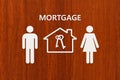 Paper house and family with mortgage text. Conceptual image Royalty Free Stock Photo