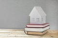 Paper house. A stack of books on the table. Royalty Free Stock Photo