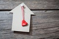 Paper house on a wooden background