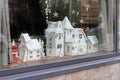 Paper houses stand on the windowsill inside the building