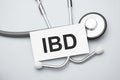 Paper with ibd on a table and grey stethoscope