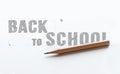 Paper with inscription word BACK TO SCHOOL near wooden pencil Royalty Free Stock Photo