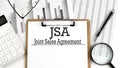 Paper with JSA - Joint Sales Agreement table on charts, business concept