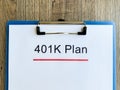Paper with 401k plan on wood table. Royalty Free Stock Photo