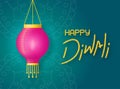 Paper lantern with fire hangs on the background green rangoli. Concept banner happy diwali with lettering and holiday lantern