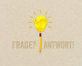 Paper light bulb and pencil with the german words for question and answer - frage und antwort on brown recycled paper background