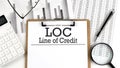 Paper with LOC - Line of Credit table on charts, business concept Royalty Free Stock Photo