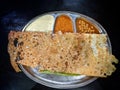 Paper Masala dosa is a South Indian meal served with sambhar and coconut chutney over fresh banana leaf. Selective focus Royalty Free Stock Photo