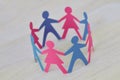 Paper men and women cut-out in a circle holding hands - Gender relationship concept Royalty Free Stock Photo