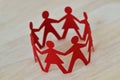 Paper men and women cut-out in a circle holding hands - Gender relationship concept