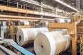 Paper mill with workers operating machinery to produce paper rolls, large vats filled with pulp, recycling and sustainability Royalty Free Stock Photo