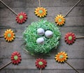 Paper nest with eggs surrounded by colorful gingerbread flowers.
