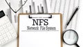 Paper with NFS Network File System a table on charts, business concept