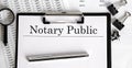 Paper with Notary Public on a table with chart
