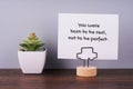 Paper note with inspirational quotes - you were born to be real not to be perfect
