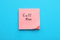 Paper note with phrase Call mom on blue background, top view Royalty Free Stock Photo