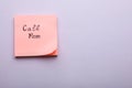Paper note with phrase Call mom on light grey background, top view. Space for text Royalty Free Stock Photo