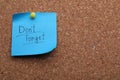 Paper note with phrase Don`t Forget pinned to cork board, space for text